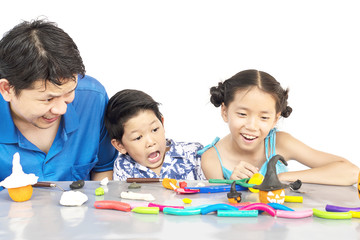 Fototapeta premium Father is playing clay toy with kid