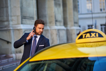 Young businessman with a taxi