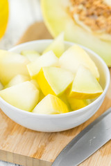 Portion of Yellow Honeydew Melon on wooden background (selective