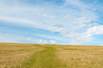 Fototapeta premium Landscape road crosses the hill against the sky