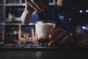 The bartender mixes a cocktail White Russian or Lebowski