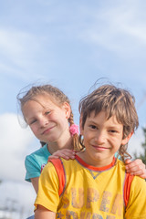 two happy kids - boy and girl - outdoor portrait