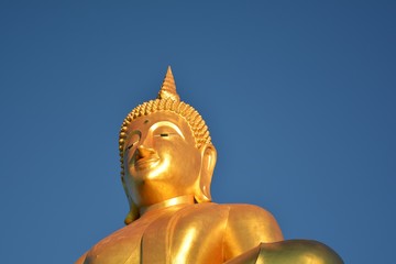 Buddha statue/ Buddha statue on a pedestal blue sky background Wait for believers to worship