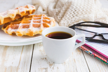 Warm knitted plaid, coffee, notebook and Belgium waffles