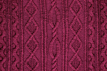 background burgundy knitted fabric with a pattern closeup