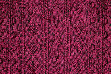 background burgundy knitted fabric with a pattern closeup