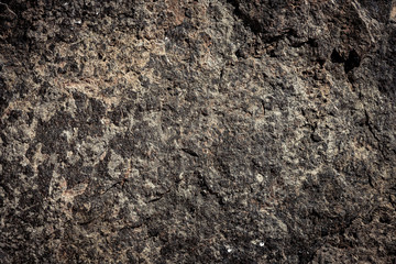 Steenachtergrond, rotsmuurachtergrond met ruwe textuur. Abstract, grungy en getextureerd oppervlak van steenmateriaal. Aarddetail van rotsen.
