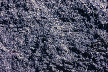 Stone background, rock wall backdrop with rough texture. Abstract, grungy and textured surface of stone material. Nature detail of rocks.