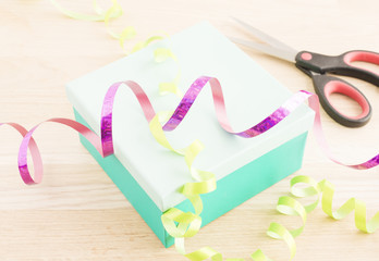 Gift wrapping for a holiday celebration, birthday or surprise party. Preparation of present with...
