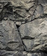 Fond de pierre, toile de fond de mur de roche avec une texture rugueuse. Surface abstraite, sale et texturée du matériau en pierre. Détail de la nature des rochers.