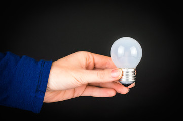 lamp in hand on black background