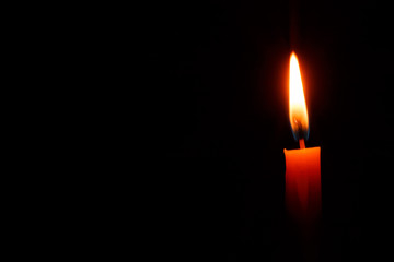 Candle on black background