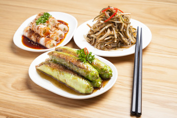 Various type of Chinese food and chopsticks on table