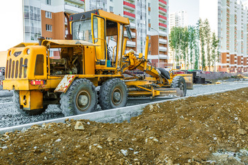 Grader working outside on road construction