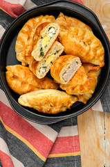 Russian pirozhki baked patties with meat and eggs