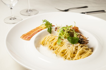 Spaghetti in white plate on dinning table