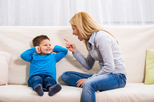 Angry Mother Is Scolding At Her Son.