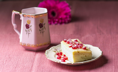 Arrangement with cake on purple tablecloth