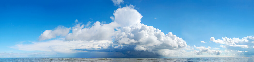 Fototapeta na wymiar Sea panorama. Huge storm cloud over the sea