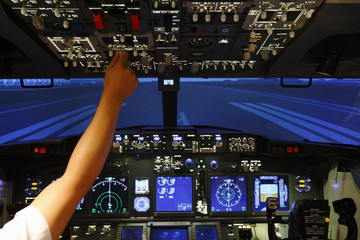 Hand control in cockpit of airplane in flight simulator