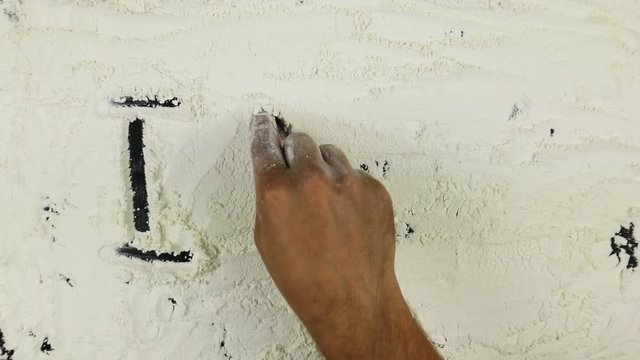 Young man writes a word I love yuo on white flour
