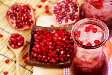Pomegranate juice set on wooden mat background