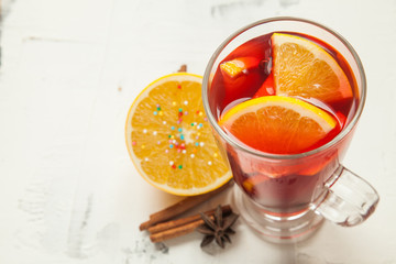 Fruit tea or mulled wine in the glass with spices