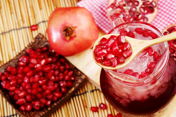 Pomegranate juice set on wooden mat background