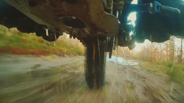 Enduro motorcycle riding in the mud. Shooting from below