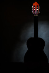 acoustic guitar, stringed instrument / lonely musical instrument which is a guitar on a black...