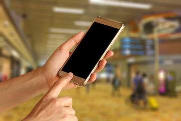 woman hand hold and touch screen smart phone, tablet,cell phone over airport terminal blur background with bokeh light