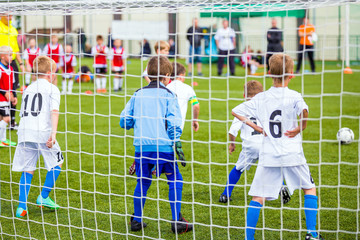 Children Play Football. Boys Kicking Football Game