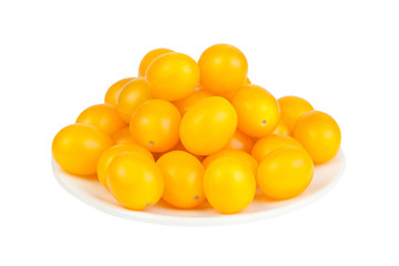 tasty ripe yellow tomatoes on white plate on white background