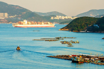 Fototapeta premium Sok Kwu Wan fisherfolks village and fish farming rafts viewed from the observation deck of the Family Walk trail on Lamma Island, Hong Kong