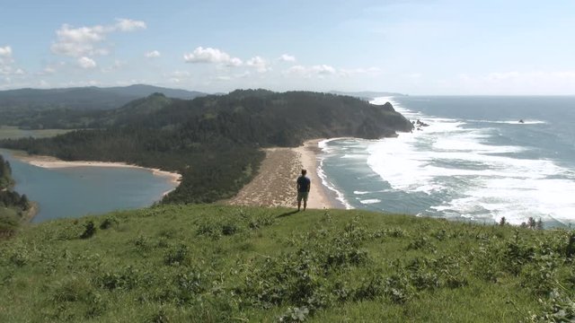 Person enjoying a beautiful view from high above the Pacific Ocean at Cascade Head in Oregon.
