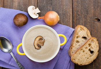 Mushroom cream soup on the wooden table. Top view.