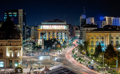 Long exposure shot of the Revolution Square,Victoria Avenue in Bucharest, Romania. Traffic and historical buildings