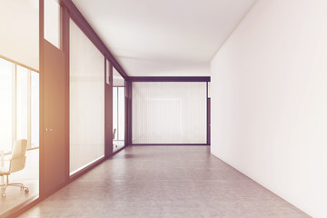 Empty office corridor with a meeting room, toned