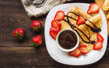 Fresh homemade crepes with strawberries and chocolate sauce