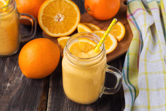 Orange fruit smoothie in the glass jar