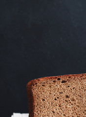 Sliced bread loaf on a black background