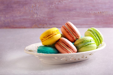 Macarons of different color on a plate