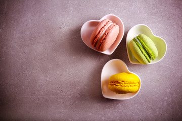Macarons of different color in a heart shape