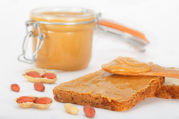 Peanut butter on a slice of toast. Peanut butter sandwich for breakfast.
