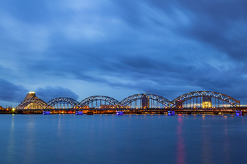 Illuminated railway bridge at night in Riga, Latvia