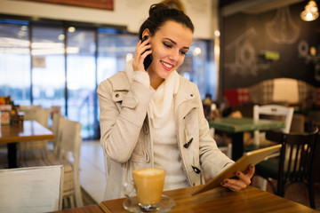 Woman using tablet in restaurant