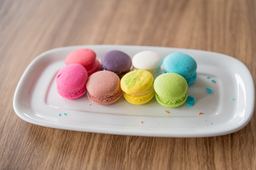 Dessert Macaroon placed in a dish with a wooden background.