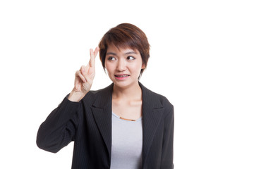 Beautiful young Asian woman cross finger.