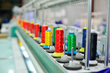 Spools of thread in the sewing equipment. The concept of sewing