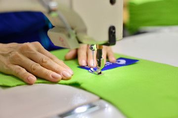 Tailoring Process - Women's hands behind her sewing